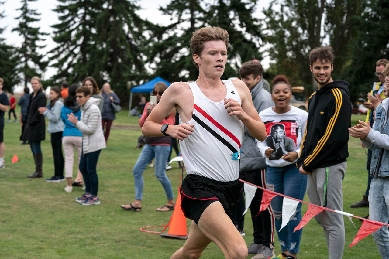 Steve Mullensky/for Peninsula Daily News Port Townsend’s Nathan Cantrell crosses the finish line in 10 minutes, 27 seconds to take the boys cross country race at Port Townsend Golf Course on Wednesday.