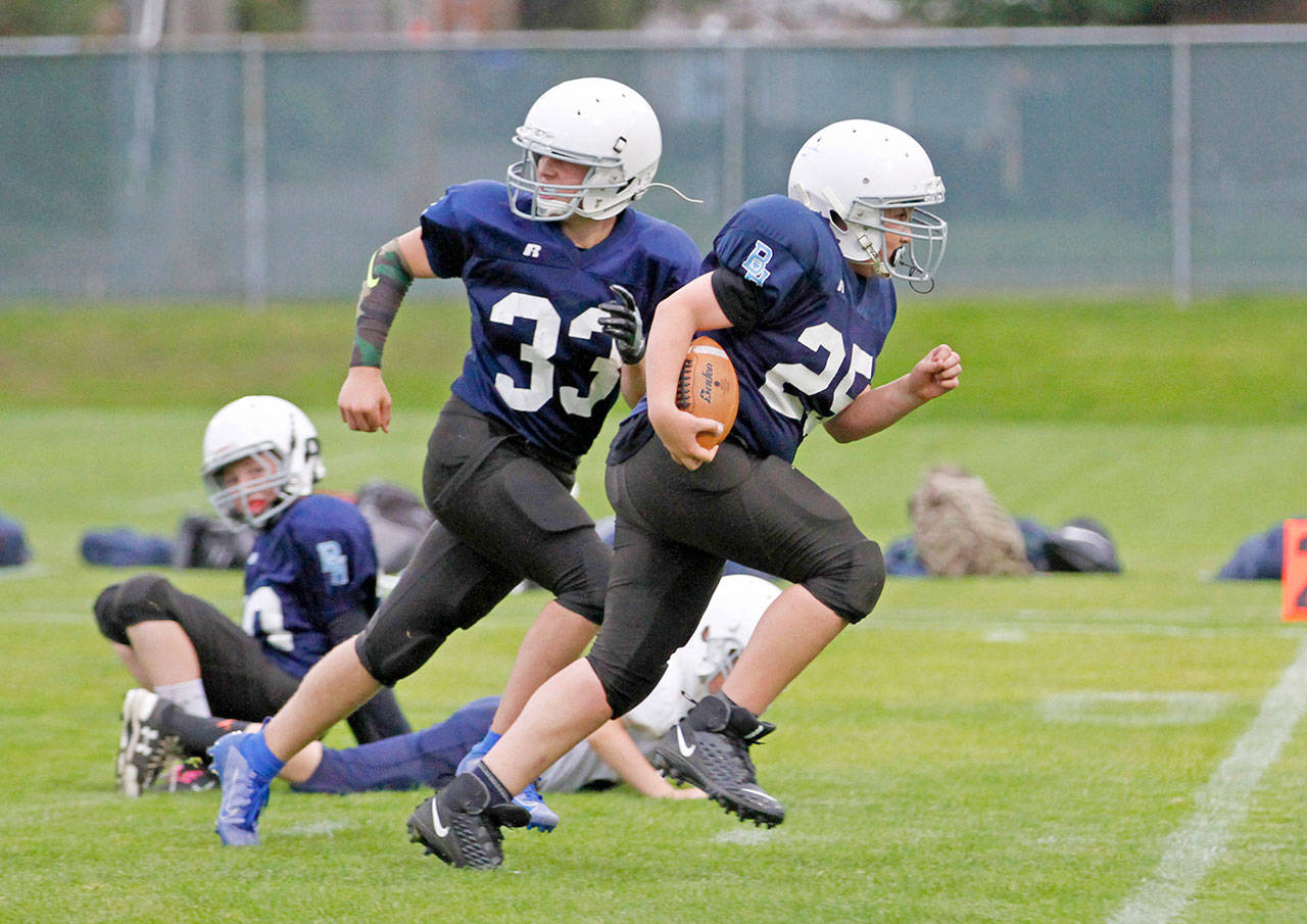 Port Townsend’s Sean Hammett, right, intercepts a pass and returns it for a touchdown during a 40-12 win over Port Angeles’ Stevens Middle School at Civic Field on Wednesday. The game was the first for the combined Port Townsend-Chimacum middle school football team.                                 Photo by Lisa Jensen