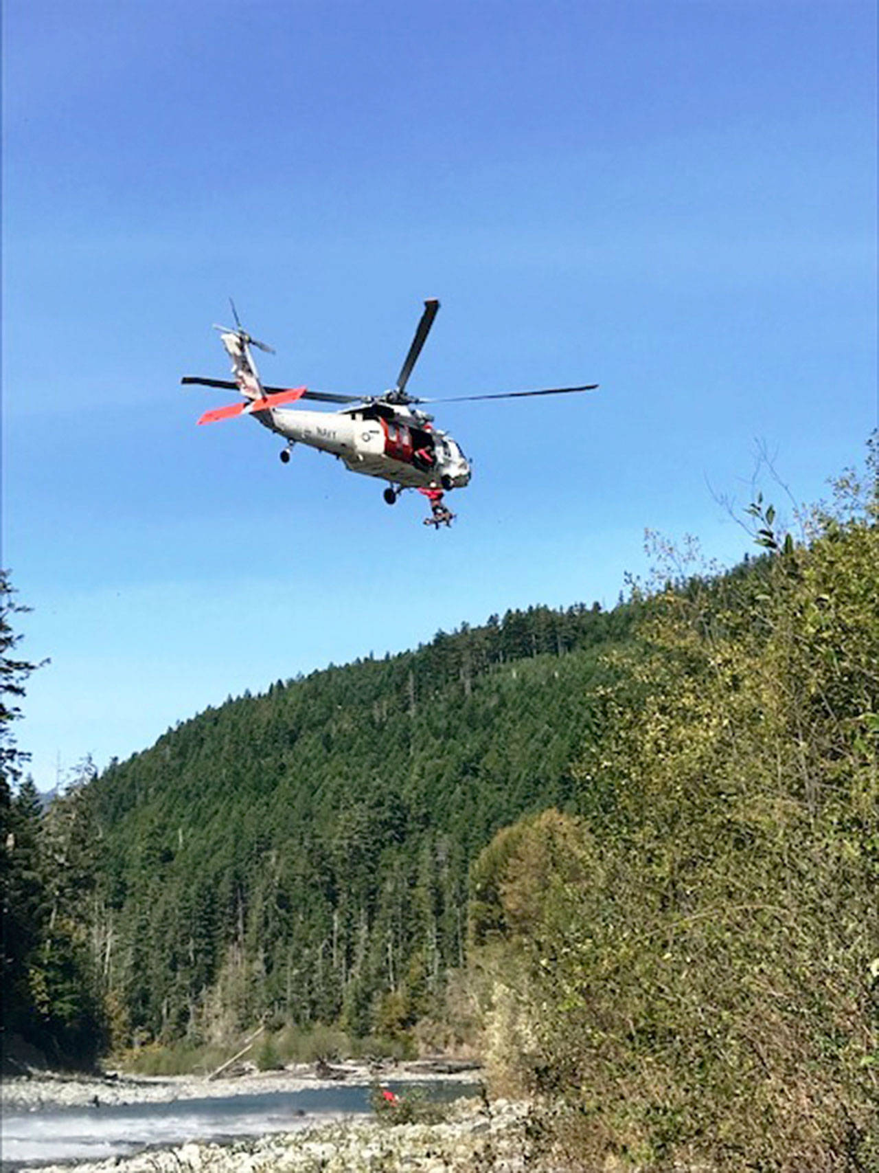 Navy helicopter hoisting injured backpacker. (National Park Service)