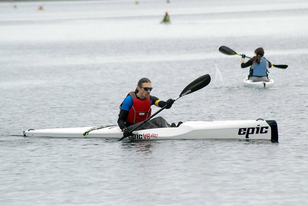 <strong>Keith Thorpe</strong>/Peninsula Daily News                                Troy Treaccar, owner of Sound Bikes & Kayaks of Port Angeles, a competetor in the “iron” category, paddles to the finish of the kayak leg of Saturday’s Big Hurt race in Port Angeles. The event featured teams and individuals taking part in a race of mountain bikes, kayaks, road bicycles and feet.