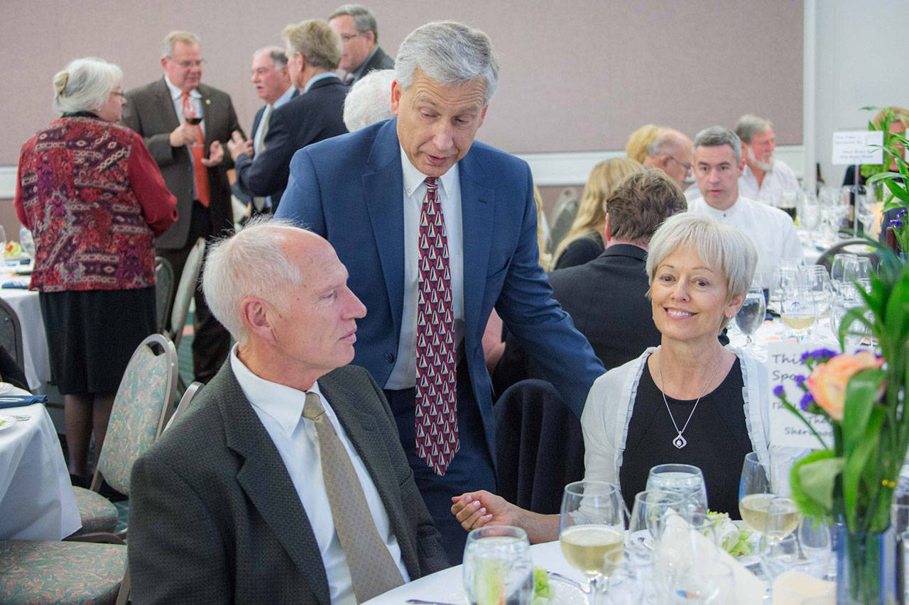 Olympic Medical Center CEO Eric Lewis, back, speaks with Bill and Esther Littlejohn of Sequim at the 2016 Harvest of Hope event. The Littlejohns will be presented with the Rick Kaps Award, an honor that recognizes organizations and individuals who have supported the Olympic Medical Cancer Center. (Justin Charon/Olympic Medical Center Foundation)