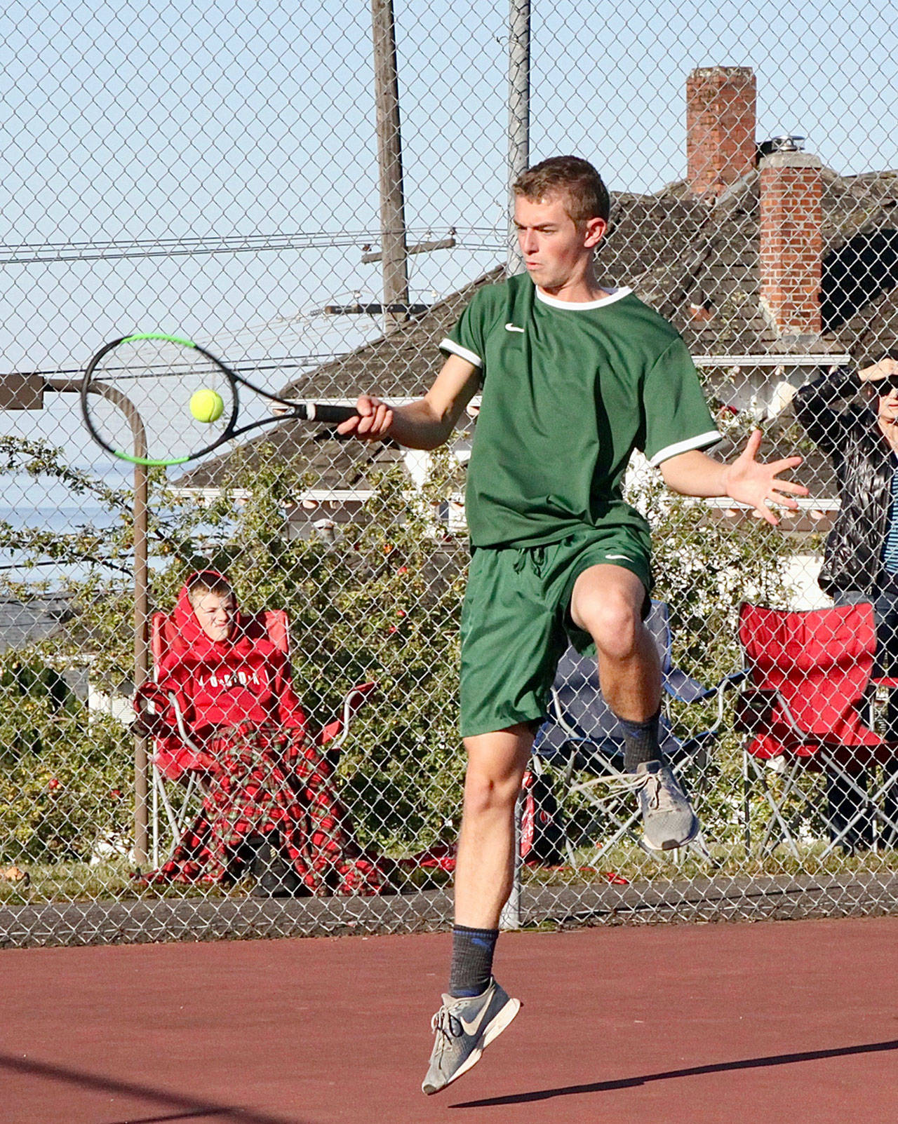 Port Angeles’ No. 1 singles tennis player Caleb Flodstrom returns a volley in his match Monday against Chimacum’s Roman Powell. Flodstrom won a hard-fought three-set match over Powell. (Dave Logan/for Peninsula Daily News)