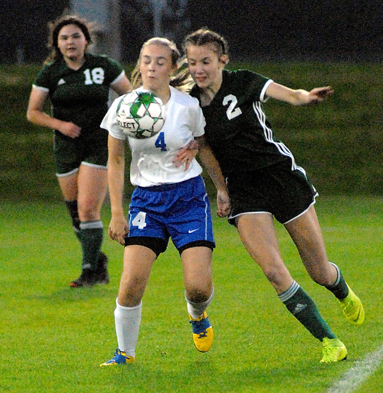 Reese Flanagan of Bremerton, center, and Port Angeles’ Catherine Brown, right, jostle along the sidelines as brown’s teammate, Kiana Watson-Charles, left, watches from behind on Tuesday night in Port Angeles. (Keith Thorpe/Peninsula Daily News)