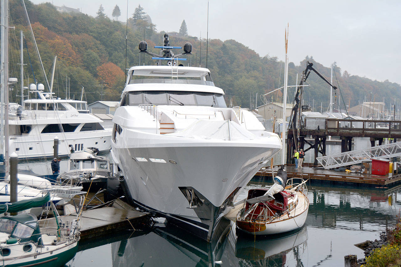 A new 125-foot Westport LLC yacht is wedged against a boat at the Port Angeles Boat Haven on Monday morning after accelerating for unknown reasons. (Paul Gottlieb/Peninsula Daily News)
