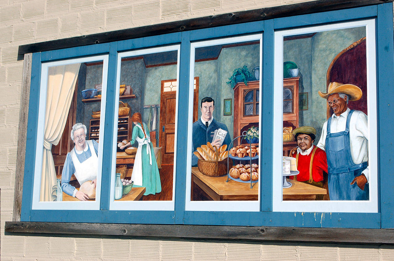 A section of the old Lehman Market murals showing Sequims history is now hanging on the side of A-1 Auto Parts, a block away from their original home on whats now the Lehman Court. building. (Conor Dowley/Olympic Peninsula News Group)