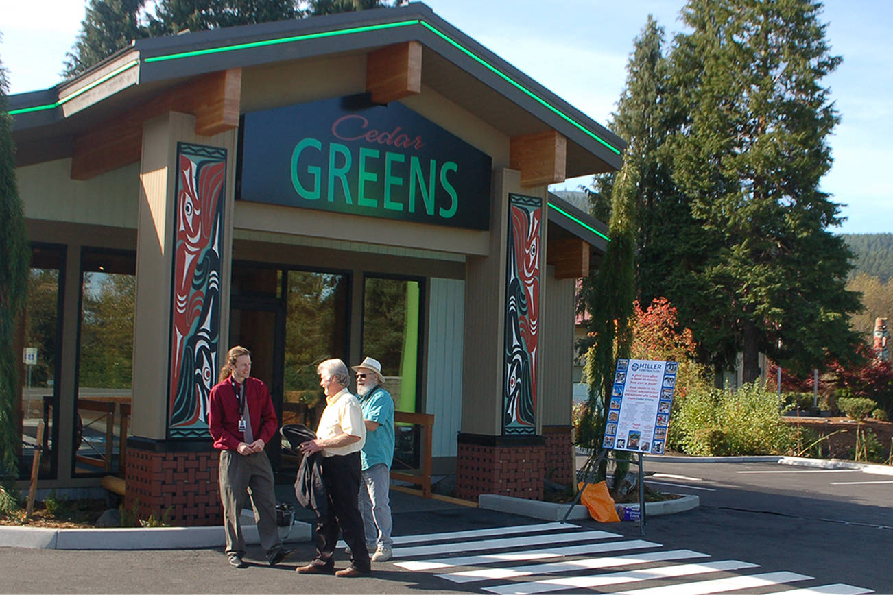 Cedar Greens general operations manager Mike Smith, left, speaks with two attendees of the grand opening for the Jamestown S’Klallam Tribe’s new cannabis dispensary store. (Conor Dowley/Olympic Peninsula News Group)