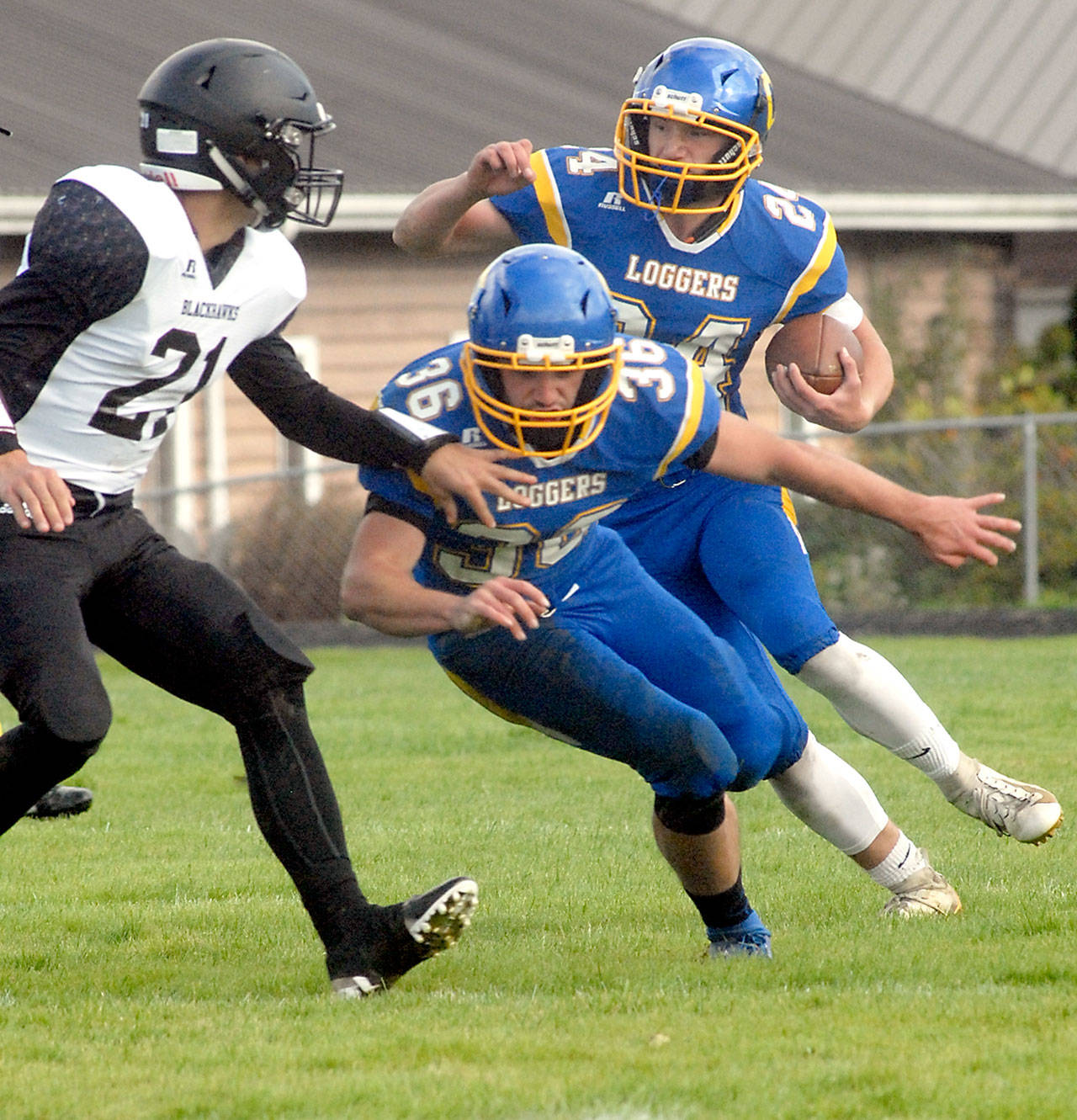 Keith Thorpe/Peninsula Daily News Crescent’s Brayden Emery, right, gets a block from his brother, Eric Emery, as they fend off the defense of Lummi Nation’s Caleb Revey, left, on Saturday in Joyce.