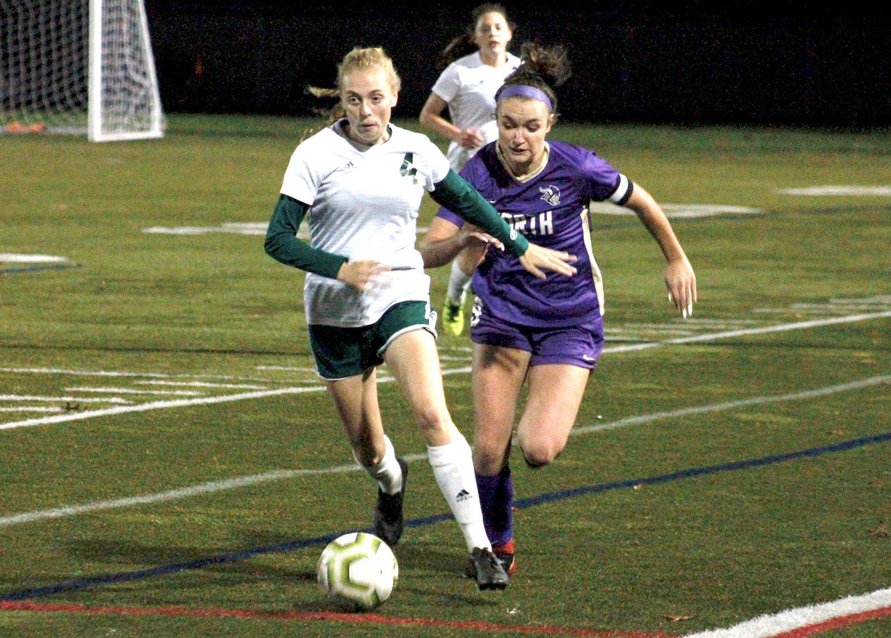 Port Angeles’ Teagan Clark tries to hold off North Kitsap’s Charlotte Bond during the Vikings’ 1-0 penalty kick shootout win in Poulsbo on Tuesday evening. By picking up a point, the Riders remain in first place in league. (Mark Krulish/Kitsap News Group)