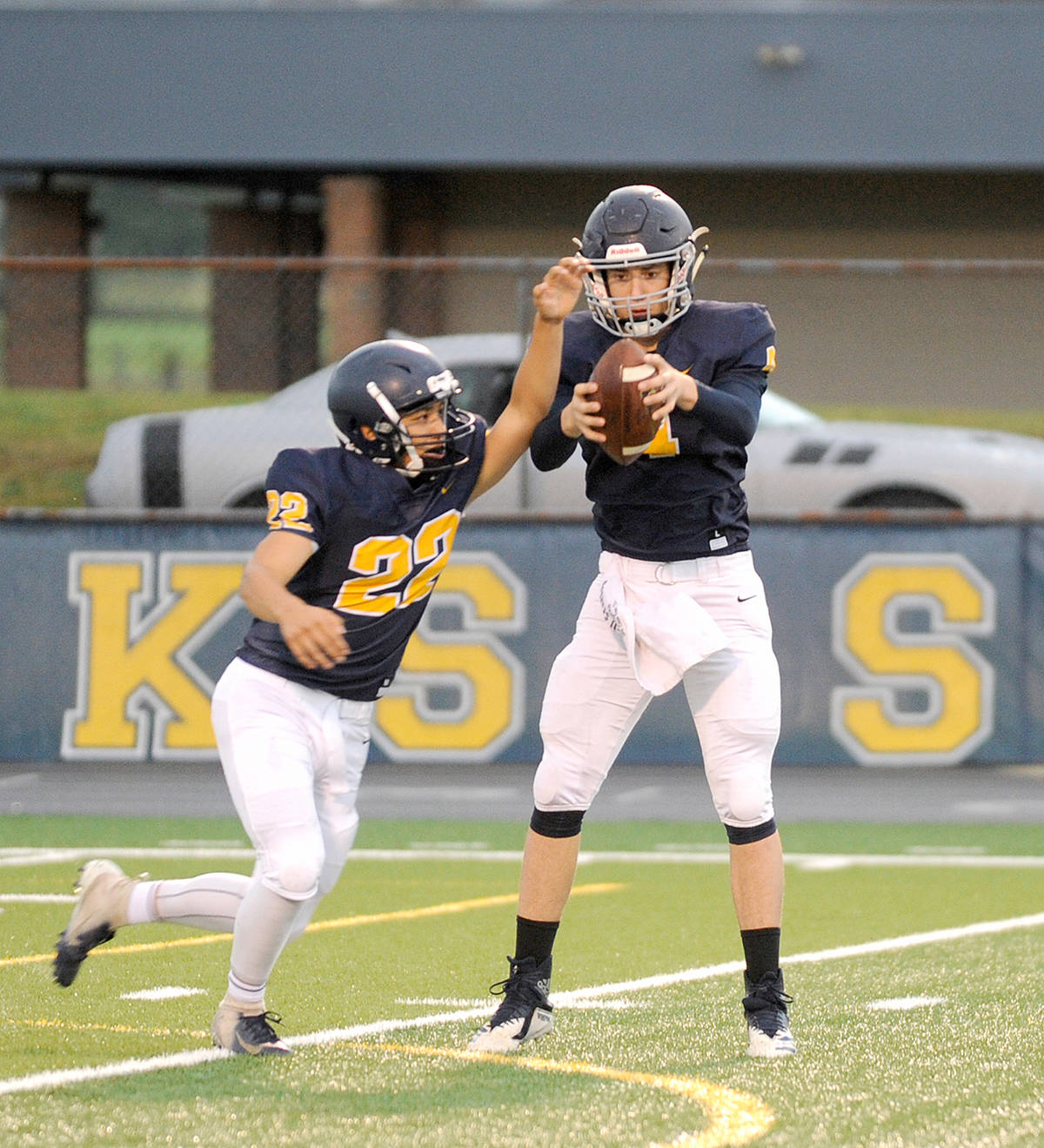 Forks quarterback Carter Windle, right, prepares to hand off the ball to running back Ricardo Barragan during a game earlier this season. (Michael Dashiell/Olympic Peninsula News Group)