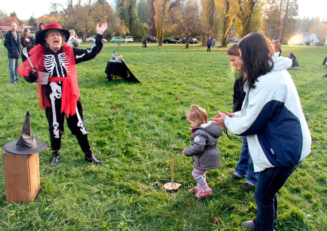 Long-time Worthington Park volunteer Carol Christiansen, dressed in costume, presides over the ring toss game                                (Eric Anderson)