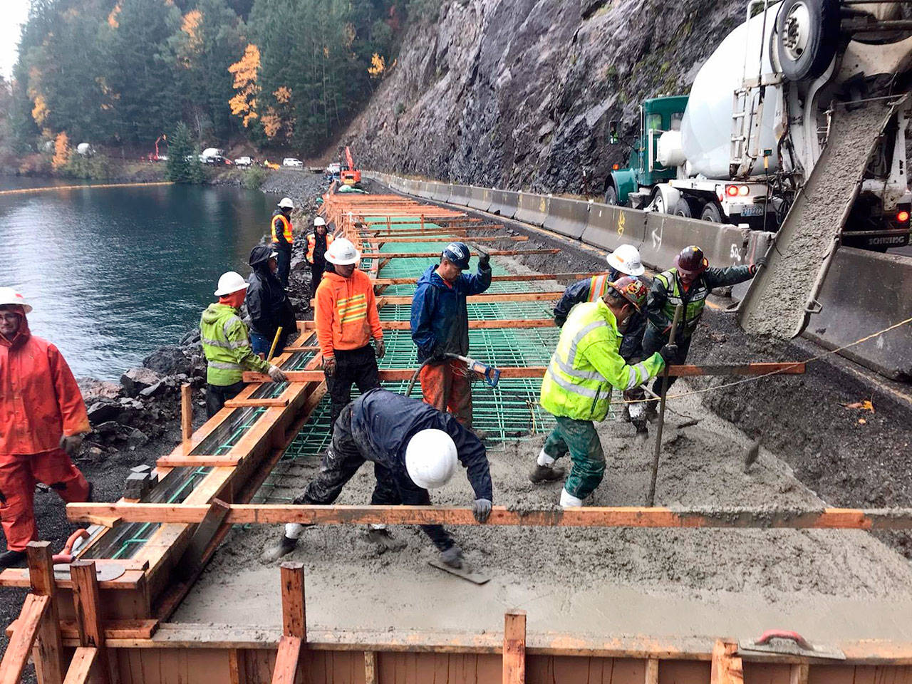 Strider Construction crew members work to restore the roadway near milepost 229 on U.S. Highway 101.