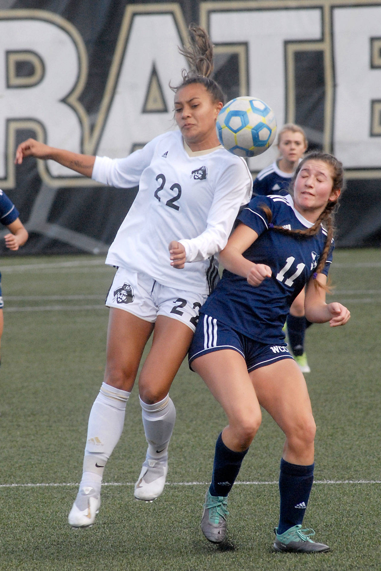 Keith Thorpe/Peninsula Daily News Peninsula’s Miya Clarke, left, fights for a header with Whatcom’s Alana Sullivan in the first half on Saturday at Wally Sigmar Field in Port Angeles.