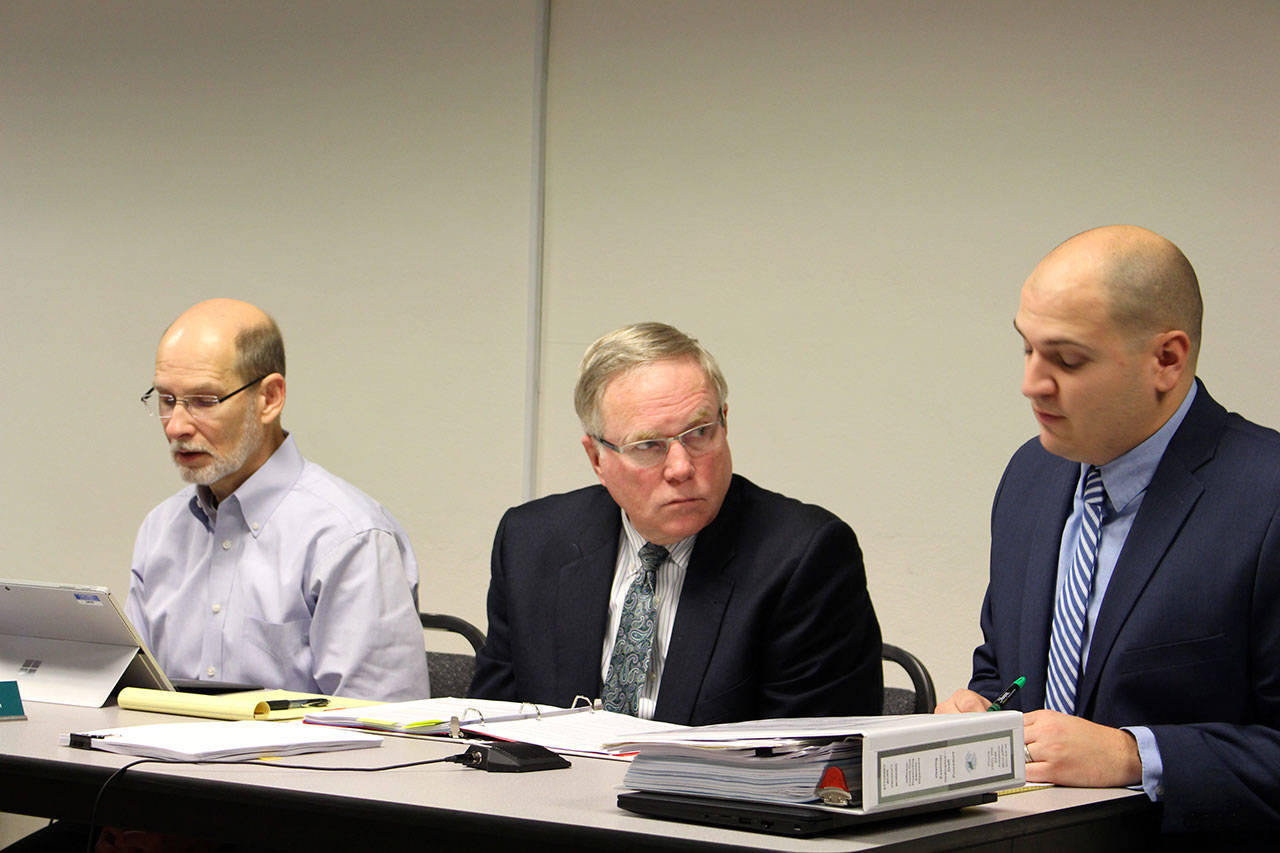 Jefferson County Administrator Philip Morley, left, Philip Hunsucker, chief civil deputy prosecuting attorney, and Austin Watkins, civil deputy prosecuting attorney, present the final draft ordinance for the hearing examiner code to the county commissioners Monday morning. (Zach Jablonski/Peninsula Daily News)