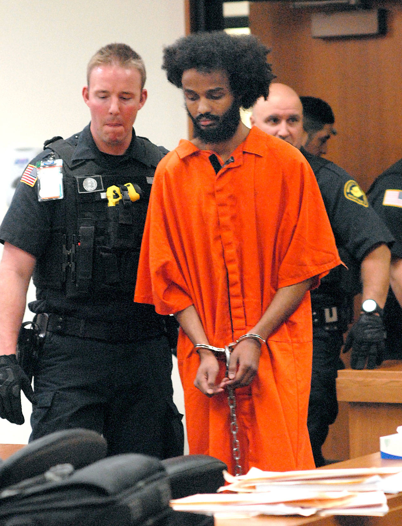 Abdinjib Ibraham, a prison inmate who allegedly tried to kill a Clallam Bay Corrections Center deputy in 2016, enters Clallam County Superior Court accompanied by state corrections security officers Wednesday in Port Angeles. (Keith Thorpe/Peninsula Daily News)