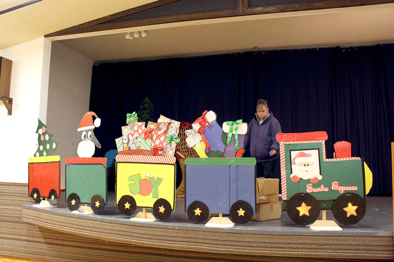 Jefferson County Fair Agriculture Superintendent Debbie Rasmussen helps set the stage where pictures with Santa will be taken at the Holiday Fair this weekend at the Jefferson County Fairgrounds. (Zach Jablonski/Peninsula Daily News)