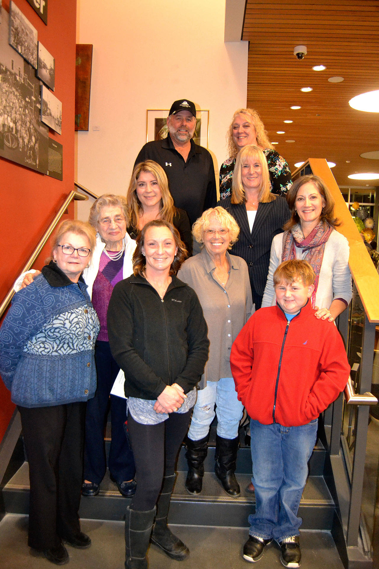 Family and friends gather to commemorate the Sequim Civic Center being named after longtime Sequim city clerk Karen Kuznek-Reese, who was unable to attend the occasion due to being in the hospital. There for the occasion were, top left, Robb Reese, husband, Paula Swisher, Washington Municipal Clerk’s Association (WMCA) president; second row, Carolyn Gallaway, Jefferson County deputy clerk, Virginia Olsen, WMCA immediate past president; third row, Helen Kuznek, mother, Mary Bower, retired Clallam Transit clerk, Joanna Sanders, City of Port Townsend clerk; bottom row, Sharon DelaBarre, past chairman City Arts Advisory Commission, Alicia Neal, daughter, and Brody Neal, grandson. Matthew Nash/Olympic Peninsula News Group