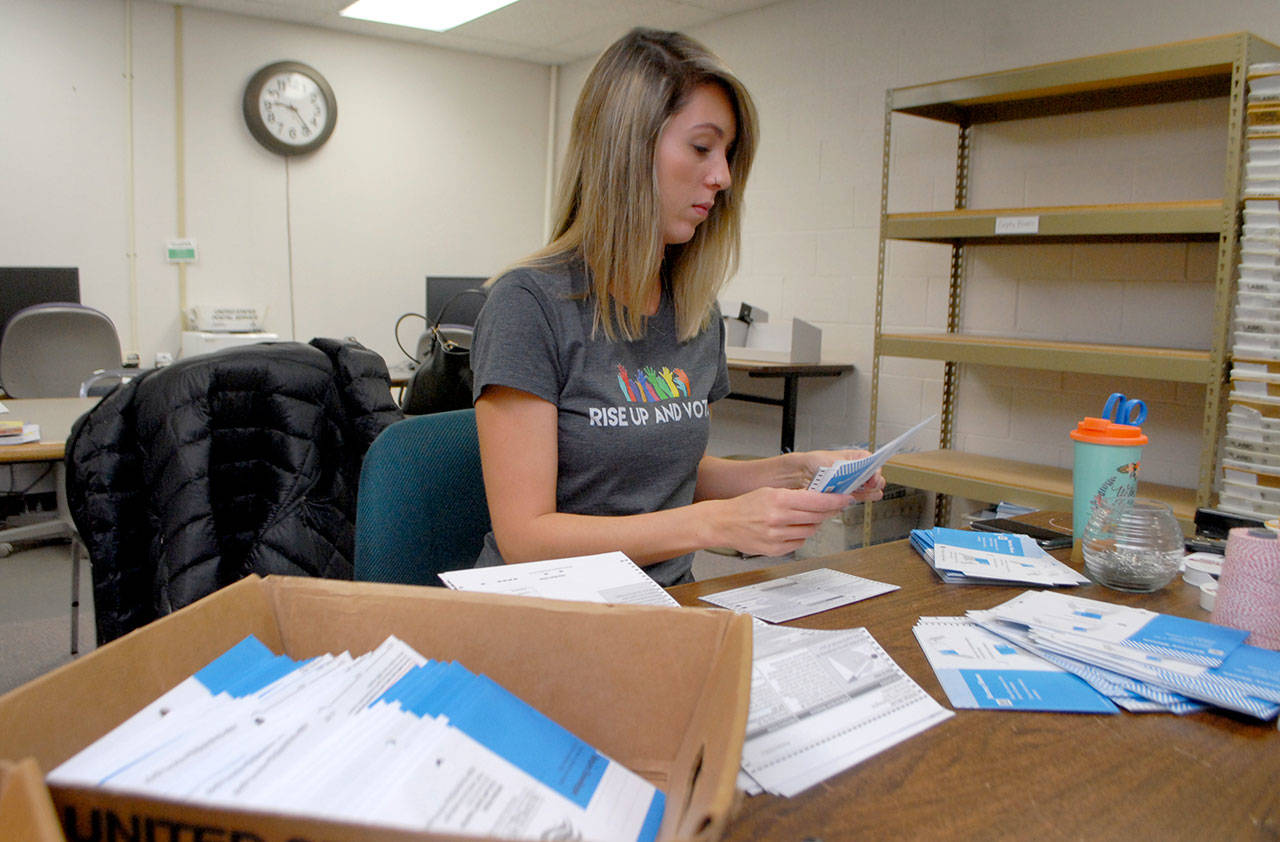 Sherry Price, voter registration coordinator for Clallam County, opens ballots during a count on Saturday morning at the county courthouse in Port Angeles. (Keith Thorpe/Peninsula Daily News)