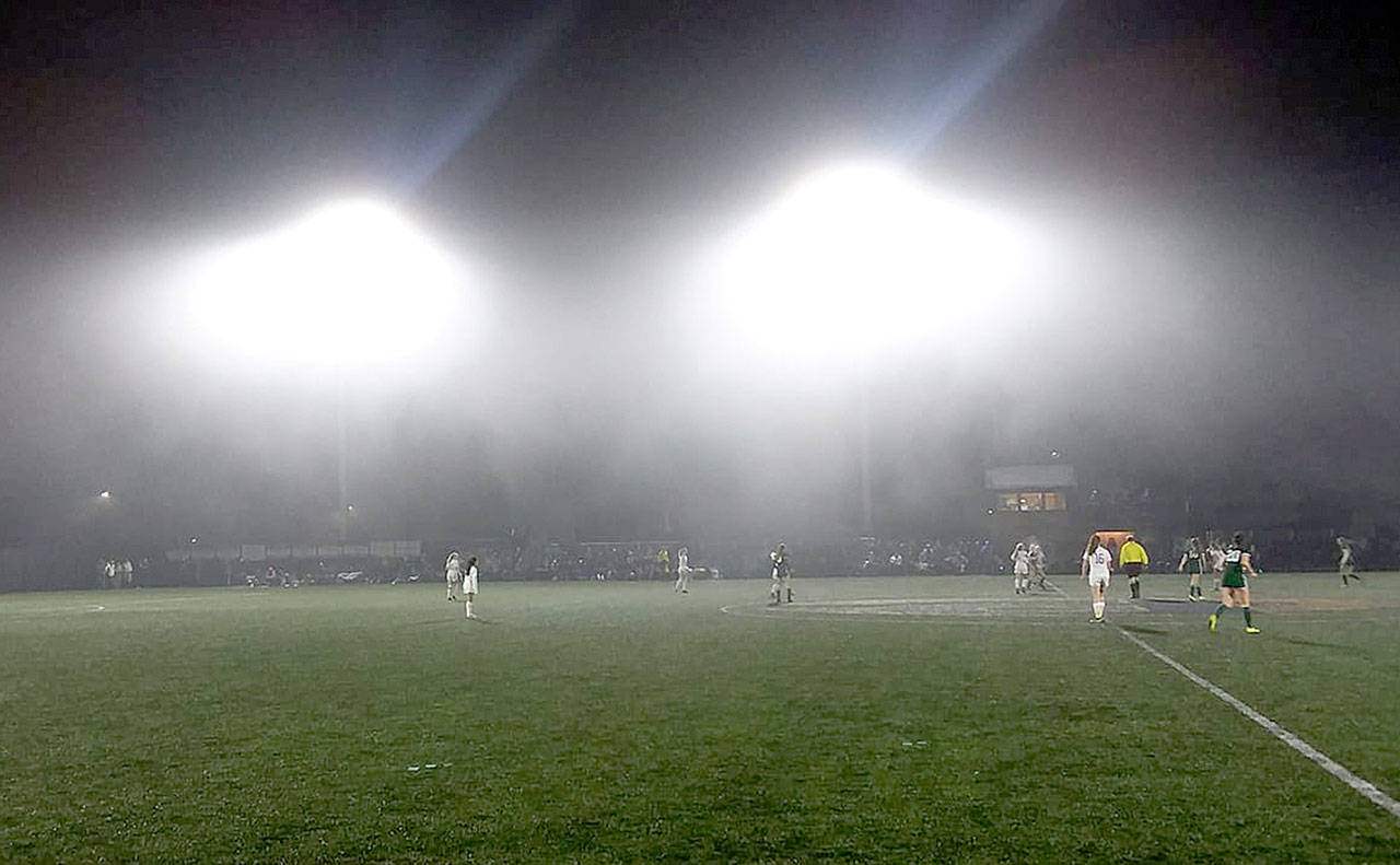 A thick cloud came down on the Roughriders-Wolves game Saturday night as the two teams battled for the right to host a state playoff game. (Pierre LaBossiere/Peninsula Daily News)