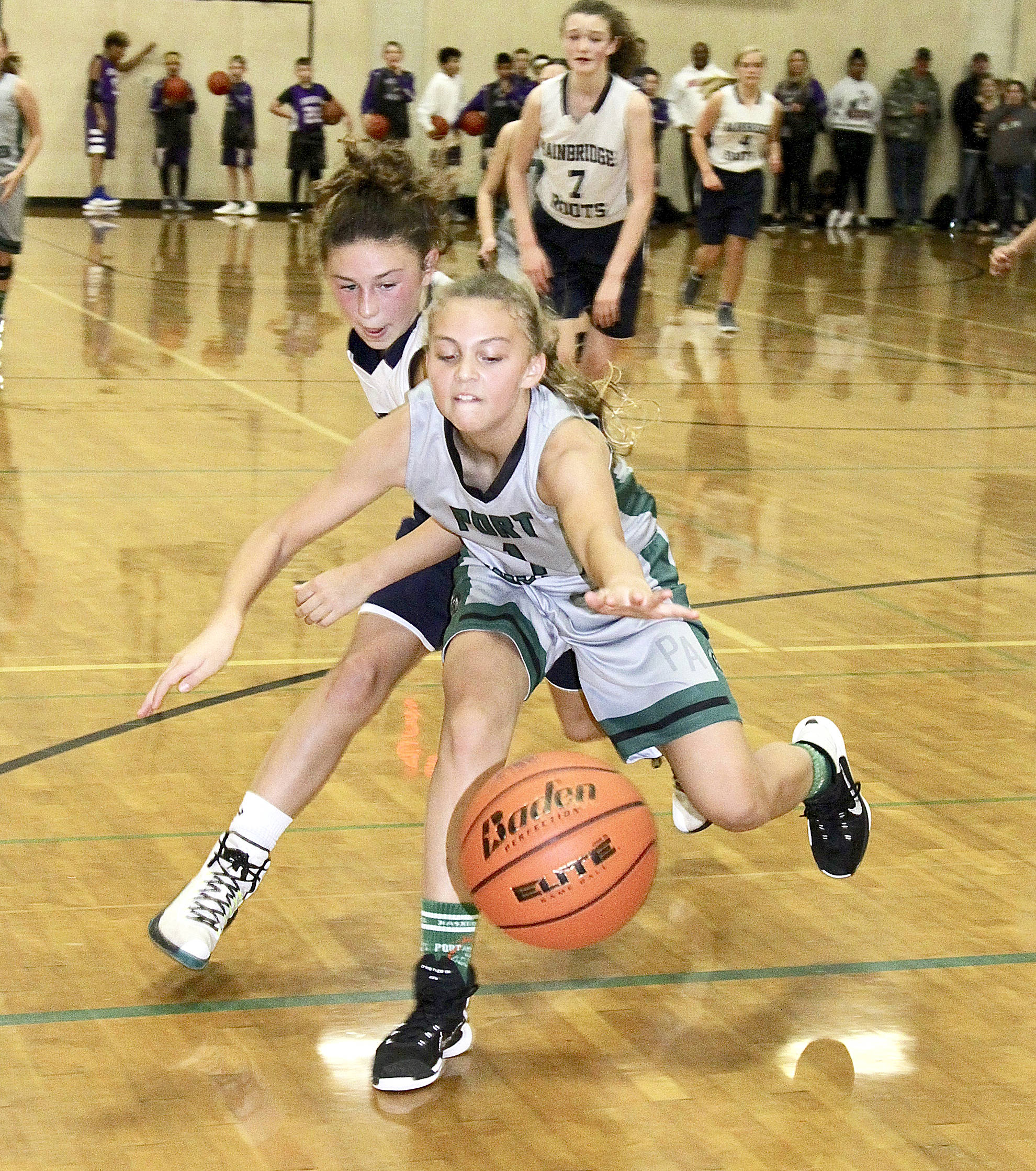 <strong>Dave Logan</strong>/for Peninsula Daily News                                The Port Angeles Parks and Recreation Department this weekend sponsored the “Tipoff Tourney” at the Port Angeles High School gym with 6th- to 8th-grade boys and girls teams participating. In the 7th-grade girls game, Port Angeles’ Kennedy Rognlien fights for the ball against a player from Bainbridge Root. Port Angeles won 29-27.