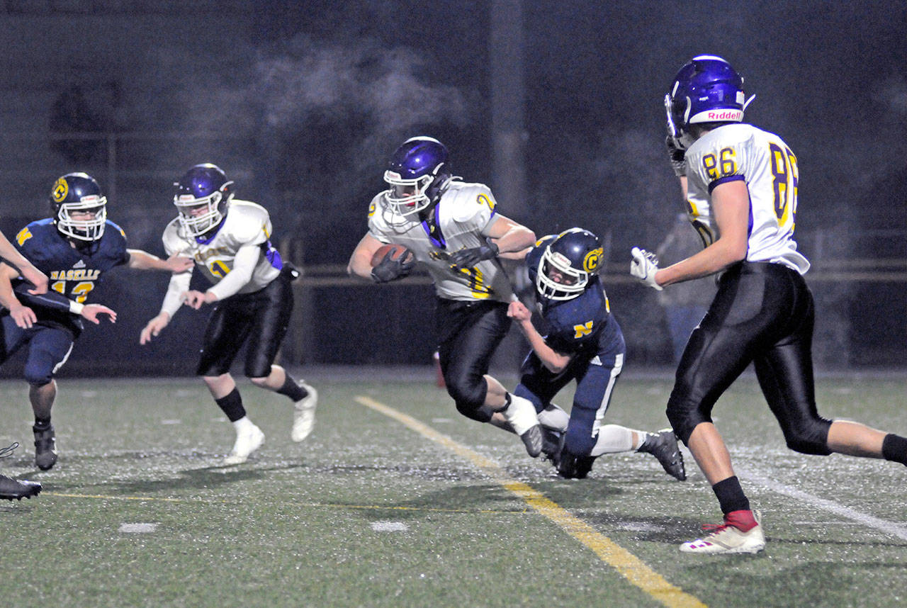 Ryan Sparks/Grays Harbor News Group Quilcene running back Bishop Budnek (2) carries the ball while Naselle defender Kolten Lindstrom grabs hold of his jersey during the first half of a 1B State Tournament game on Friday at Stewart Field in Aberdeen.