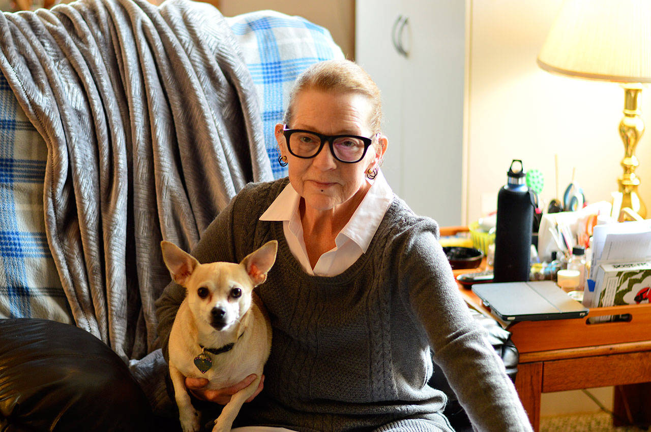 Lee Daniels poses with Momo, one of her two furry companions. (Diane Urbani de la Paz/for Peninsula Daily News)