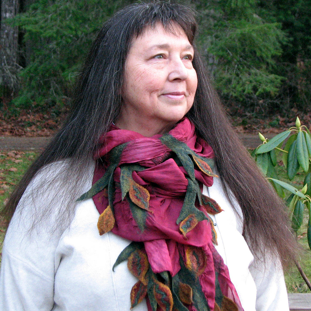 Michelle Johnson, of Port Angeles’ Laughing Cloud Studio, models one of the scarves she’ll offer at the Makers’ Market, opening this Thursday through Dec. 22 at the Port Angeles Fine Arts Center.