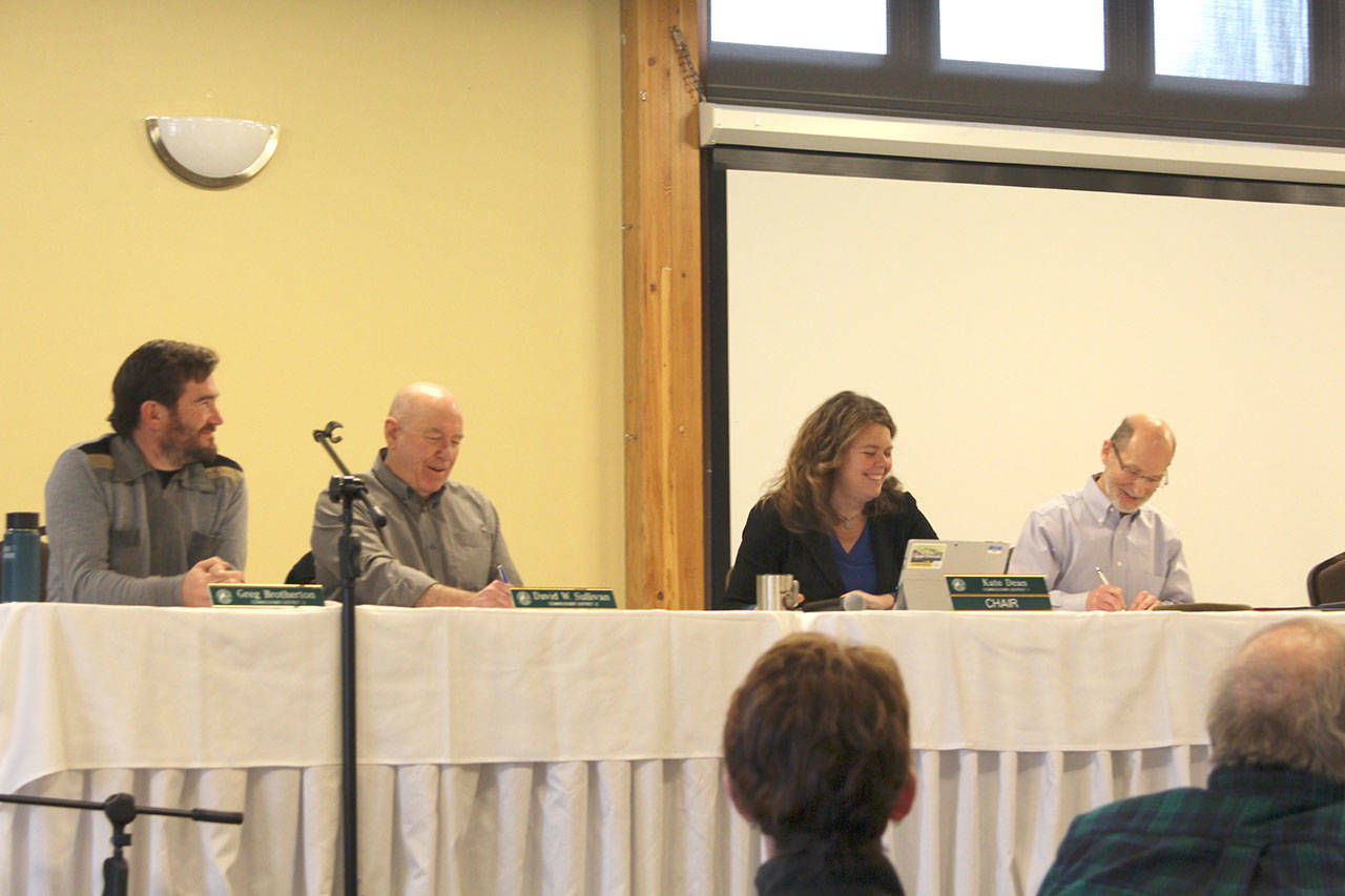 Jefferson County Commissioners Greg Brotherton, left, David Sullivan and Kate Dean, along with county Administrator Philip Morley lead the public hearing Monday afternoon in the Commons of Fort Worden, where the commissioners enacted a new moratorium for commercial gun ranges until March. (Zach Jablonski/Peninsula Daily News)
