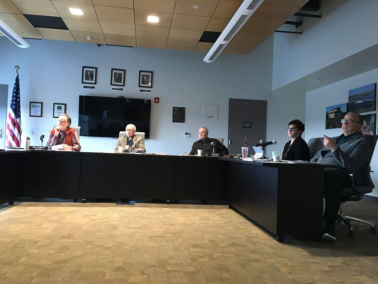 Clallam County Public Utility District Commissioners David Anderson, left, Jim Waddell and Will Purser view a budget presentation with Communications Manager Nicole Clark and General Manager Doug Nass. (Rob Ollikainen/Peninsula Daily News)