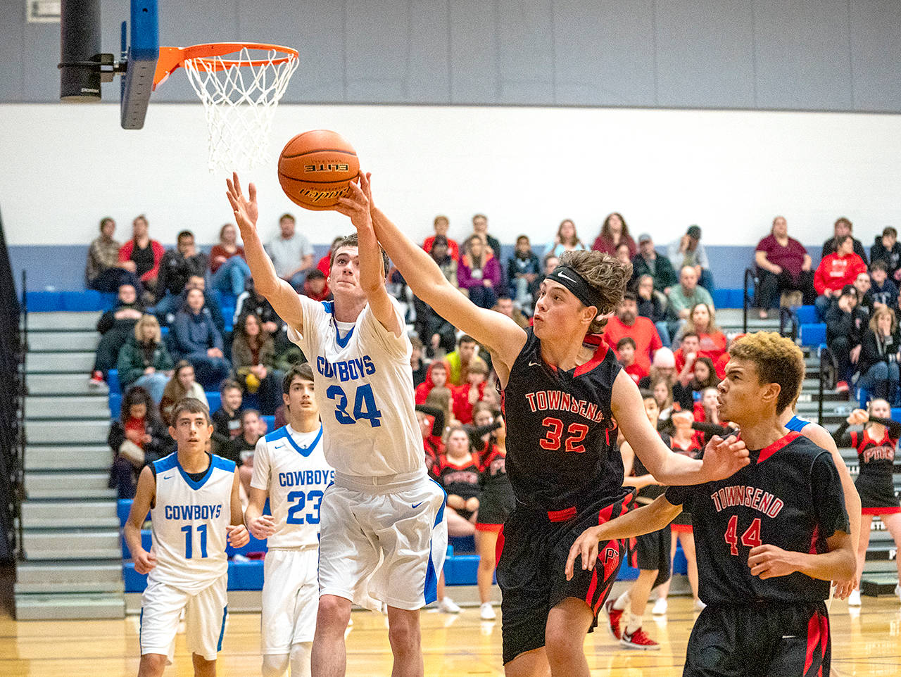 Chimacum’s Michael Bacchus, left, and Port Townsend’s Evan Toner, go after a rebound during the team’s rivalry game Wednesday in Chimacum. (Steve Mullensky/for Peninsula Daily News)