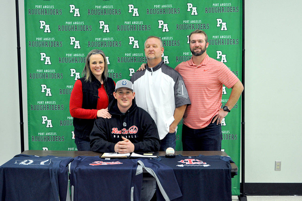 Port Angeles senior Brody Merritt, second from left, signs a letter of intent to play baseball for Lower Columbia College. Merritt is joined by, from left, his mom Kerri, father Rob and Port Angeles graduate and Lower Columbia head coach Eric Lane.                                Photo by: Vivian Elvis Hansen/Peninsula Daily News