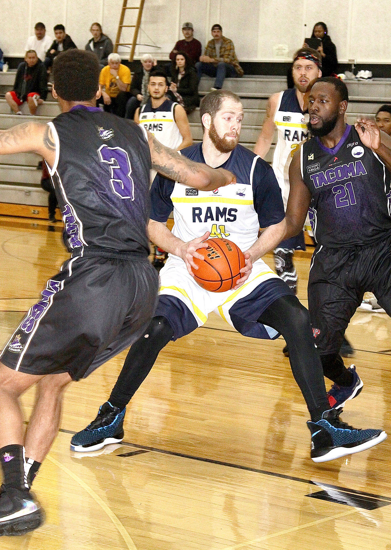 Port Angeles Rams center Ben Lierly (51) tries to find a path to the basket guarded by two Tacoma King defenders Sunday at the Peninsula College gym. The Rams stayed close to the Kings but fell 94-88. (Dave Logan/for Peninsula Daily News)