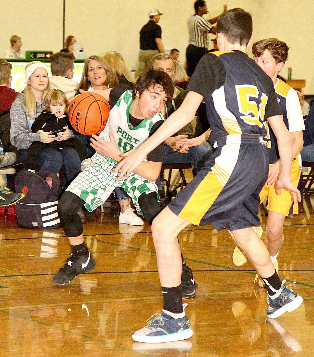 Kaiden Charles of the Port Angeles seventh-grade boys basketball team tries to fake out a Bainbridge Root defender at the annual Martin Luther King Jr. Basketball Tournament this weekend. Bainbridge won this game 57 to 15. (Dave Logan/for Peninsula Daily News)