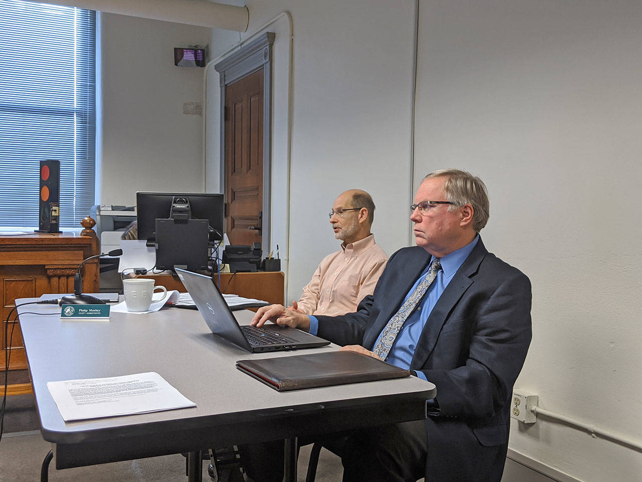 Jefferson County Administrator Philip Morely, left, sits with Chief Civil Deputy Prosecuting Attorney Philip Hunsucker as Hunsucker briefs the county commissioners on the shooting range ordinance changes Monday morning at the Jefferson County Courthouse. (Zach Jablonski/Peninsula Daily News)