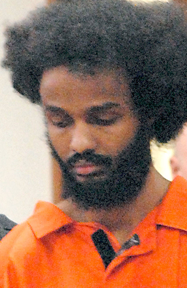 Abdinjib Ibraham, the prison inmate who allegedly tried to kill a Clallam Bay Corrections Center deputy in 2016, enters Clallam County Superior Court in Port Angeles accompanied by federal corrections security officers in October 2019. (Keith Thorpe/Peninsula Daily News file)