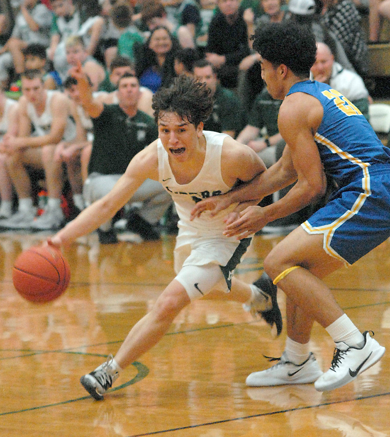 Port Angeles’ Gary Johnson, left, swings past the defense of Bremerton’s Kaipo Retome on Tuesday in Port Angeles. (Keith Thorpe/Peninsula Daily News)