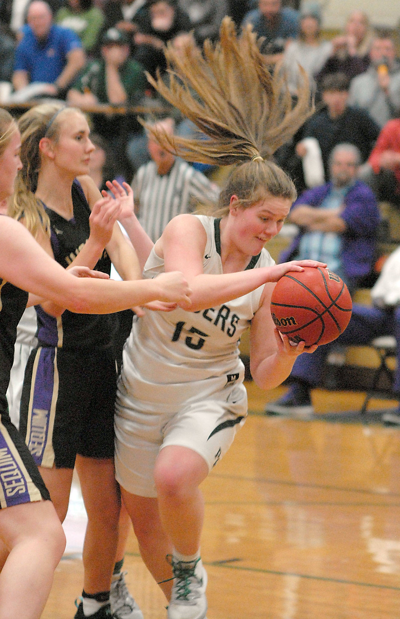 Port Angeles’ Myra Walker, right, grabs a rebound from Sequim’s LeeAnn Raney, left, and Hannah Wagner on Thursday, Feb. 6, 2020, night at Port Angeles High School. (Keith Thorpe/Peninsula Daily News)