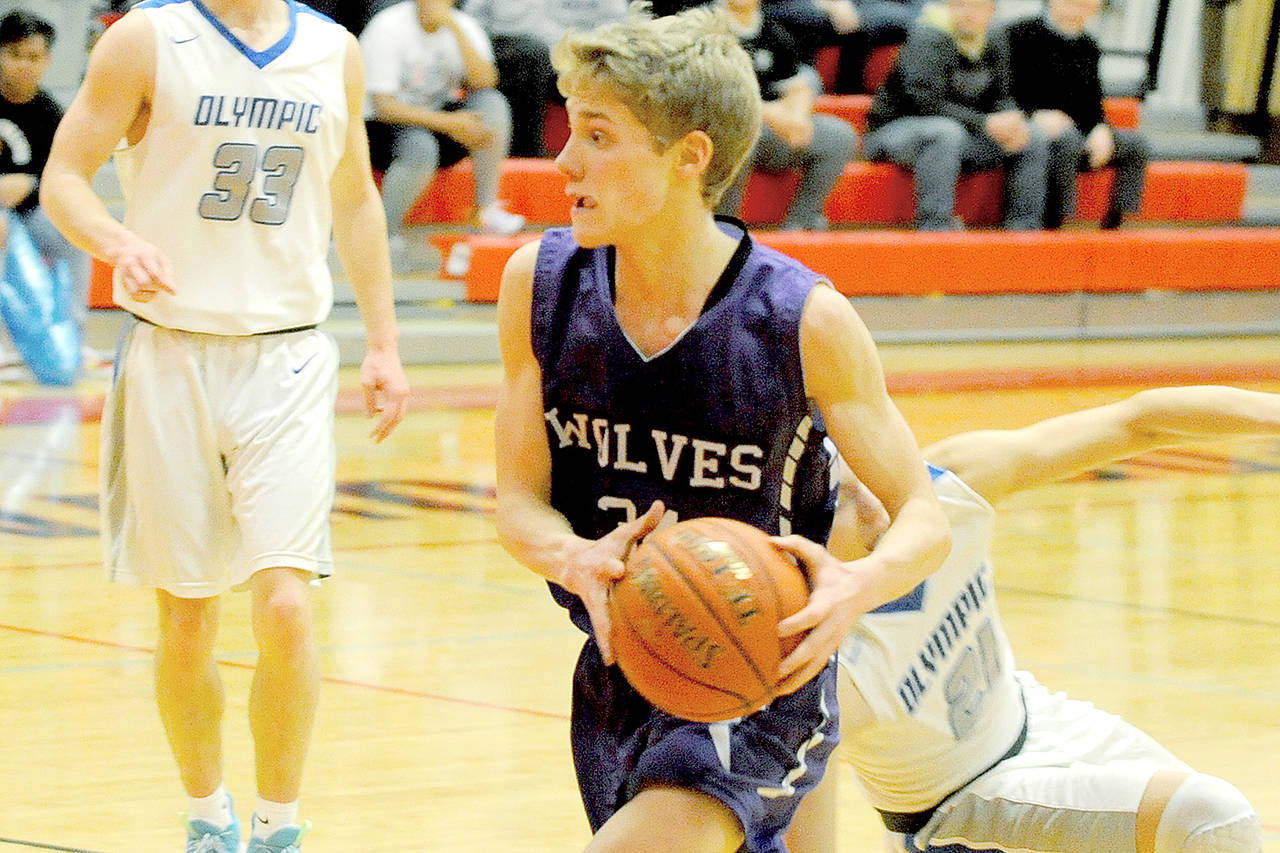 Sequim’s Erik Christiansen moves with the ball during the Wolves’ 59-47 loss to Olympic on Saturday, Feb. 8, 2020, in a playoff tiebreaker at Port Townsend High School. (Conor Dowley/Olympic Peninsula News Group)