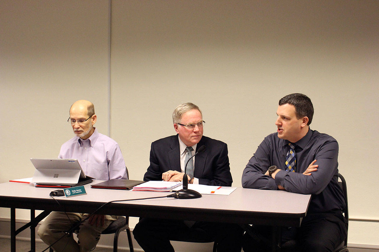 From left, Jefferson County Administrator Philip Morley, county Deputy Civil Prosecuting Attorney Philip Hunsucker and Prosecuting Attorney James Kennedy discuss the county joining the OPNET agreement with commissioners Tuesday. (Zach Jablonski/Peninsula Daily News)