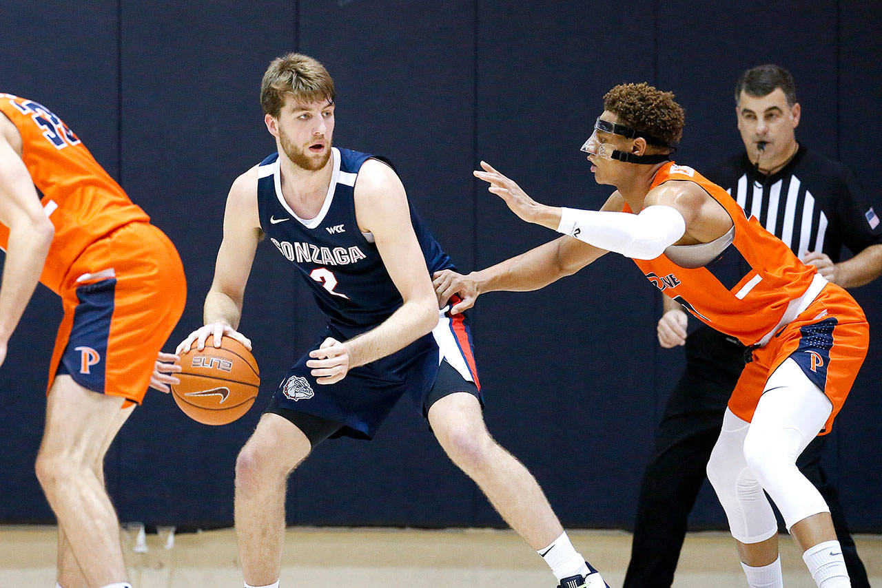 Gonzaga forward Drew Timme (2) dribbles against Pepperdine forward Kameron Edwards (20) during an NCAA college basketball game between Pepperdine and Gonzaga Saturday, Feb. 15, 2020, in Malibu, Calif. Pepperdine won 89-77. (Ringo H.W. Chiu/The Associated Press)