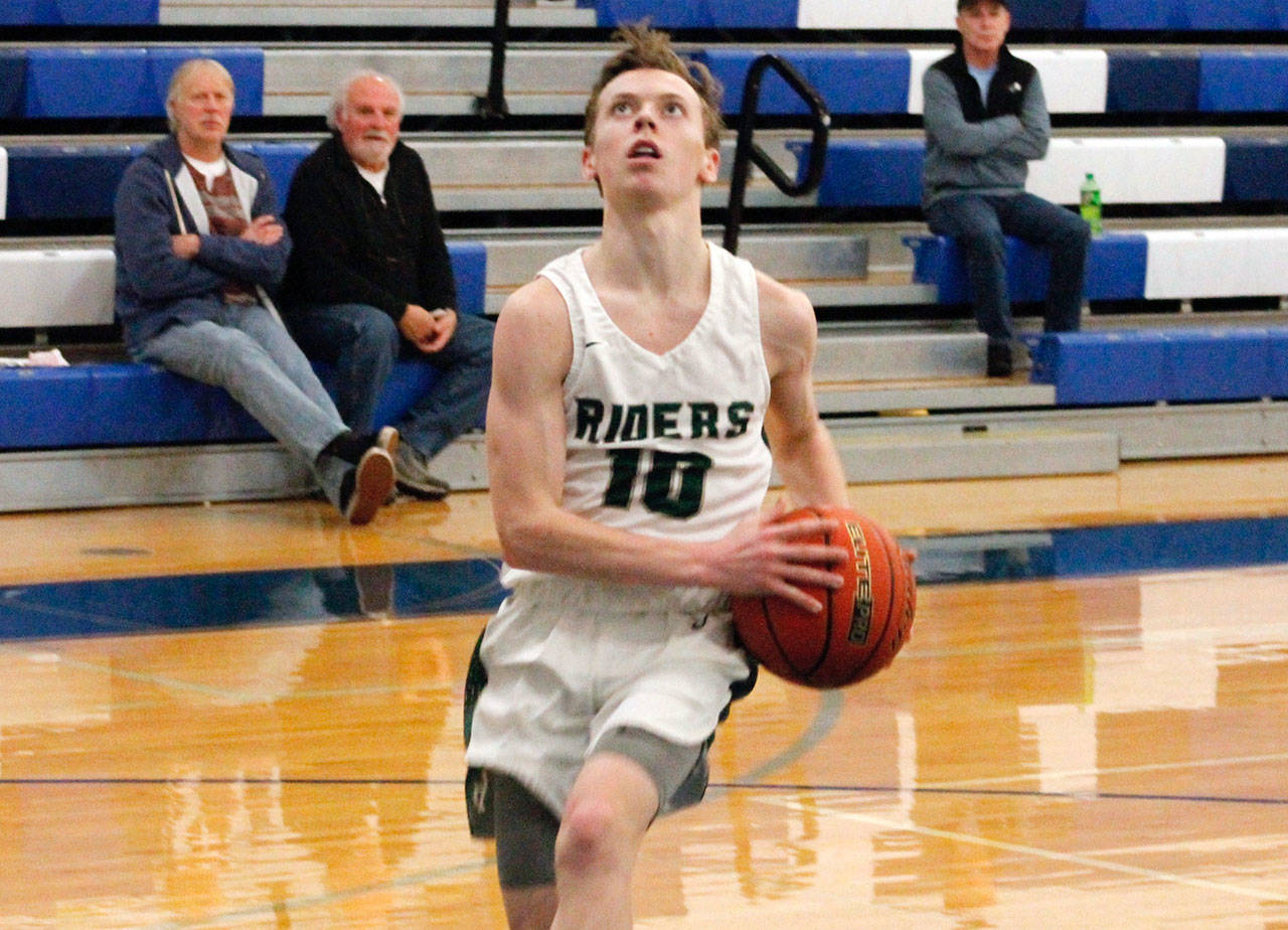 Port Angeles’ Dru Clark breaks free for an uncontested layup in his team’s 72-55 win over Olympic in the district tournament. (Mark Krulish/Kitsap News Group)