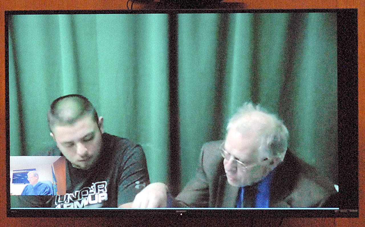Alejandro Aguiler-Rojas, left, appears in Clallam County Superior Court by video link with attorney Harry Gasnick on Thursday, Feb. 20, 2020, for his first appearance on charges of second-degree murder. (Keith Thorpe/Peninsula Daily News)