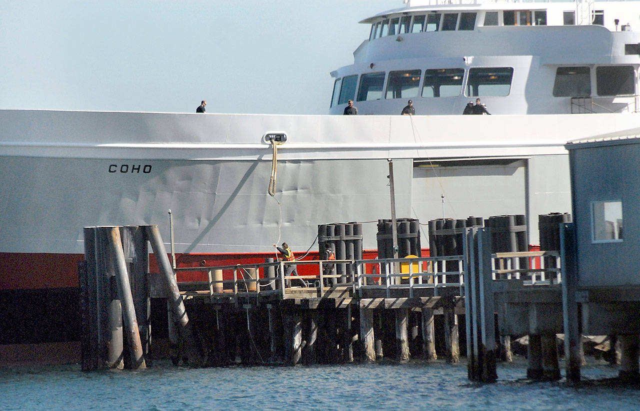 Dock workers grab the rope to secure the ferry MV Coho as it arrives in Port Angeles on Wednesday on a scheduled sailing from Victoria. (Keith Thorpe/Peninsula Daily News)