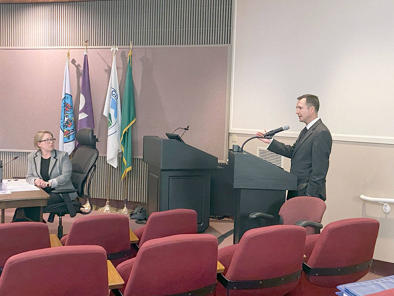 Port Angeles Mayor Kate Dexter, left, listens as Clallam County Prosecuting Attorney/Coroner Mark Nichols describes delays at the State Patrol crime and toxicology labs. (Rob Ollikainen/Peninsula Daily News)