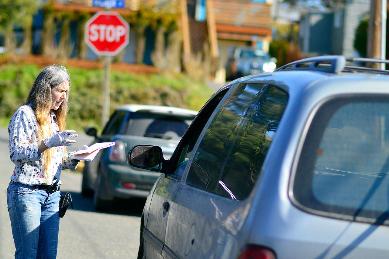 Port Townsend Food Bank manager Shirley Moss provides curbside service Wednesday, March 18, 2020. The food pantry will open for its weekly seniors’ day Saturday, March 21, 2020. (Diane Urbani de la Paz/for Peninsula Daily News)