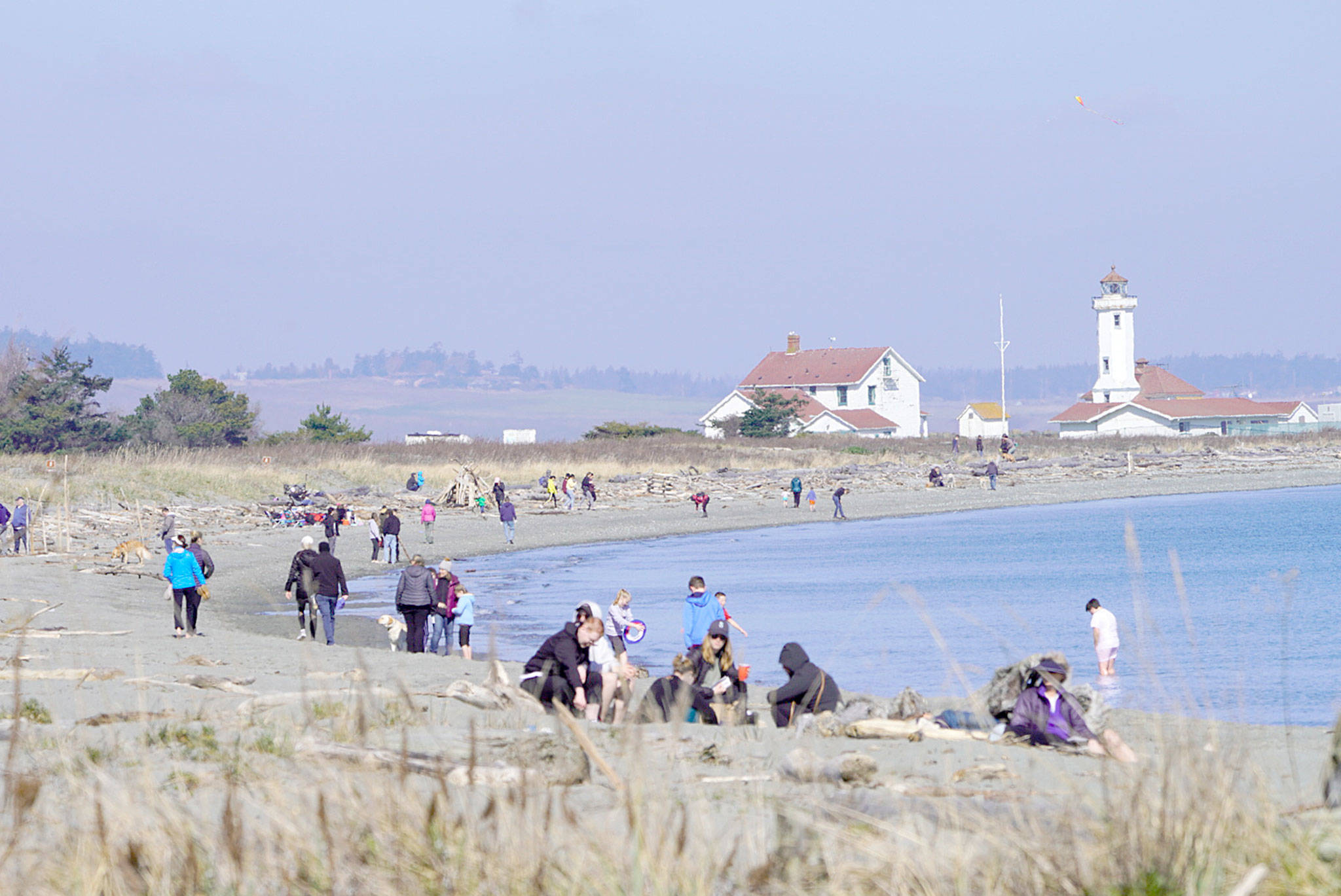 Streams of visitors at Fort Worden State Park on Saturday ignore warnings of staying home and sheltering in place to slow the spread of COVID-19. (Steve Mullensky/for Peninsula Daily News)