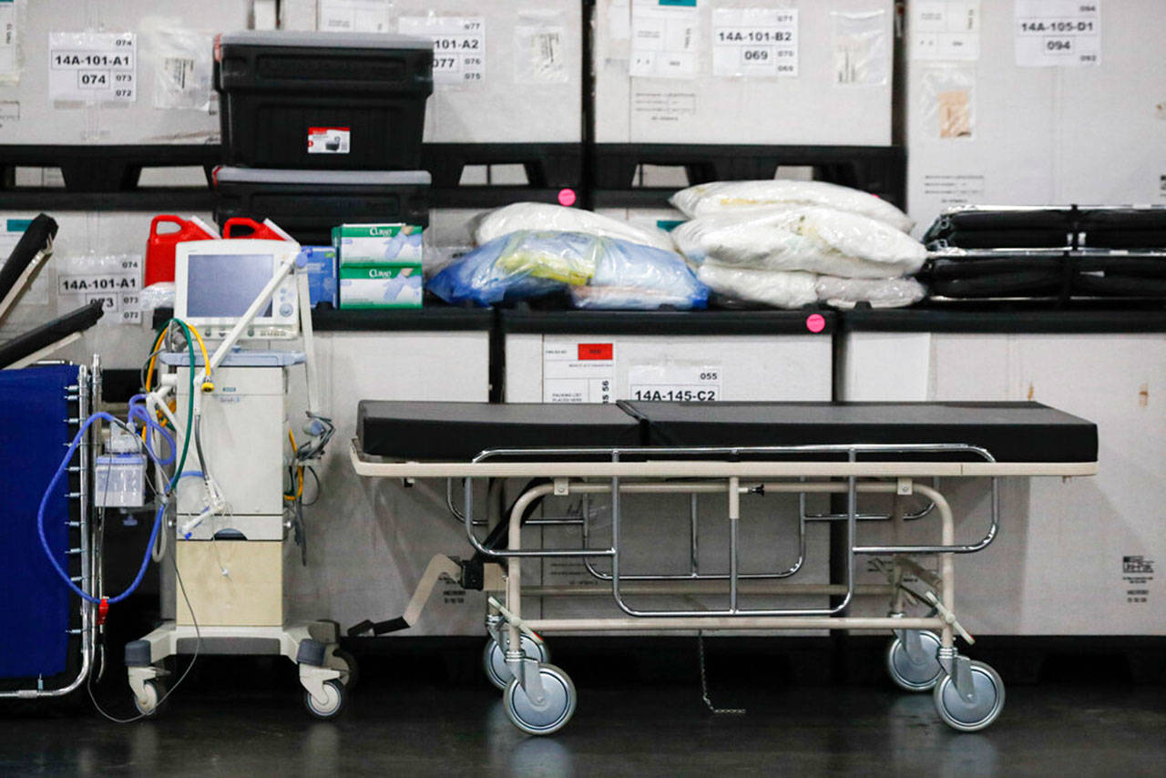 This Monday, March 23, 2020, file photo shows medical supplies and a stretcher displayed before a news conference at the Jacob Javits Center in New York. Health care workers are dreading the prospect of deciding which patients would get a ventilator that could save their lives. (John Minchillo/Associated Press file)