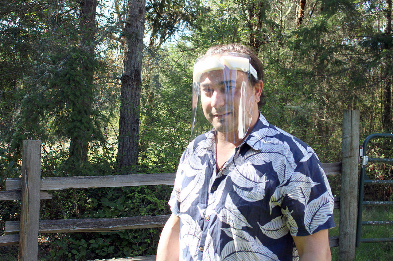 Presto Fab project lead Steve Sullivan wears one of the face shields that he and his team designed and fabricated from vinyl, foam, weatherstripping and elastic on Friday afternoon. (Zach Jablonski/Peninsula Daily News)