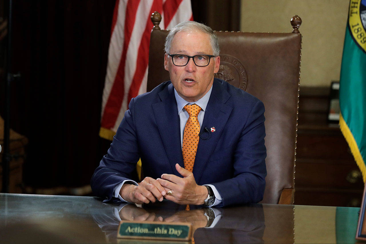 Washington Gov. Jay Inslee sits at his desk and rehearses a speech Tuesday, April 21, 2020, at the Capitol in Olympia, Wash., minutes before going live to address the public on the state’s next steps in addressing the coronavirus outbreak. Inslee said the state will not be able to lift many of the stay-at-home restrictions implemented to fight the coronavirus by May 4, the date through which the existing directive is currently in place. (Ted S. Warren/Associated Press)
