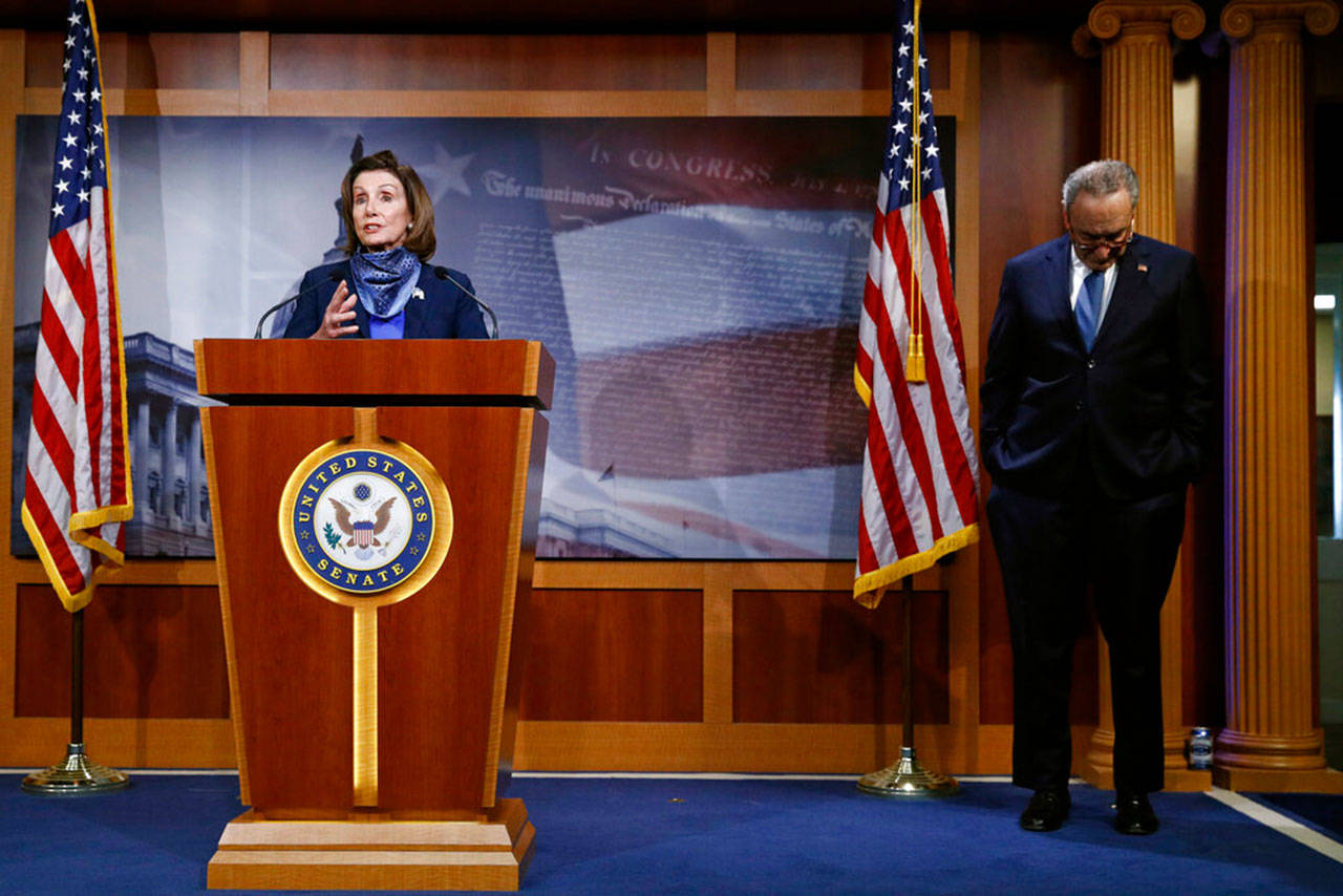 House Speaker Nancy Pelosi of California speaks with reporters alongside Senate Minority Leader Sen. Chuck Schumer of New York after the Senate approved a nearly $500 billion coronavirus aid bill Tuesday, April 21, 2020, on Capitol Hill in Washington. (Patrick Semansky/Associated Press)