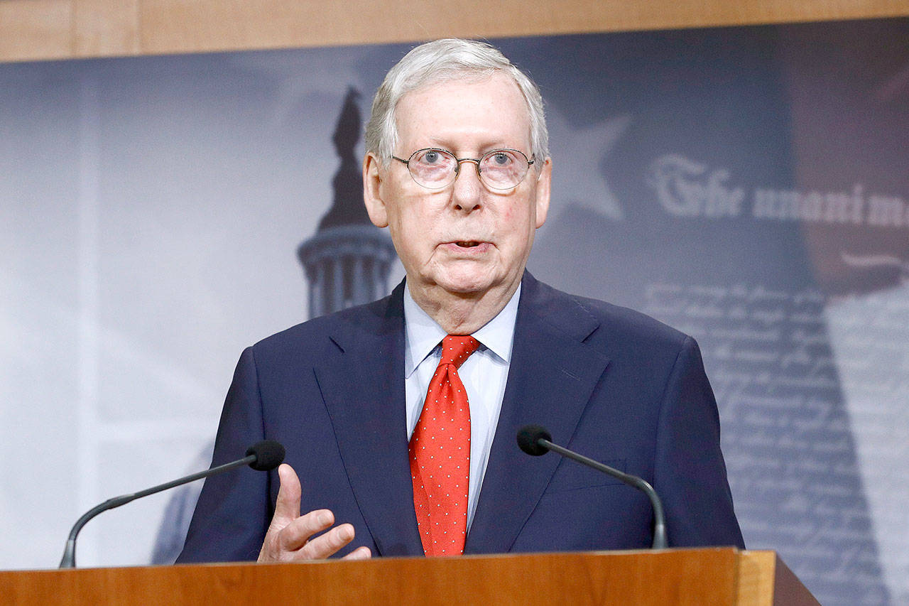 In this April 21, 2020, file photo, Senate Majority Leader Mitch McConnell of Kentucky speaks with reporters after the Senate approved a nearly $500 billion coronavirus aid bill on Capitol Hill in Washington. House Speaker Nancy Pelosi shelved a proposal for proxy voting this week after Republicans objected. In the Senate, McConnell rejected a GOP remote vote proposal. He expects Congress to return May 4 as planned. (Patrick Semansky/Associated Press file)
